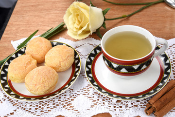 cup of tea with cheese on wooden table, brazilian breakfast