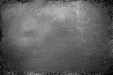 Abstract monochrome surface with traces of dirt and scratches, gray tonality.