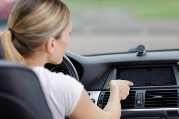 woman turns on air conditioning in a car