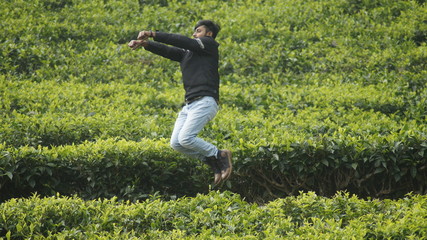 young man jumping in the field