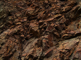 Bright red brown stone background. Golden rock textura. Mountain close-up.