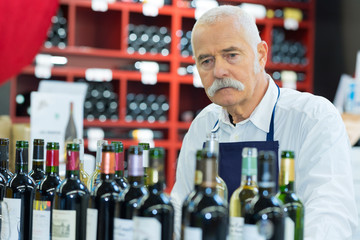 senior man working in the wine cellar