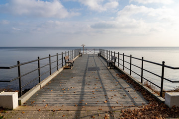 Obraz premium A small pier over the bay in Central Europe. A small bridge over the sea.