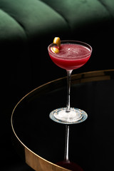 Fresh cocktail glass on glass table in night club restaurant