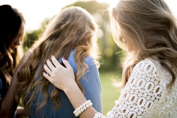 Closeup shot of a female blessing her friends with a blurred background