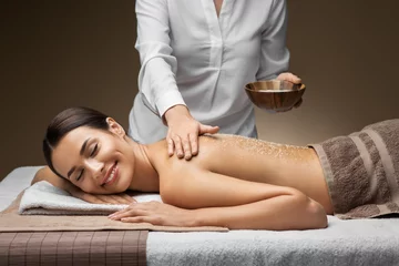 Poster wellness, beauty and relaxation concept - beautiful young woman having salt massage at spa © Syda Productions