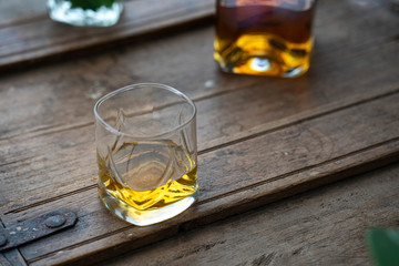 Glasses with bourbon on used oak barrel 
