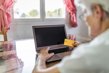 older woman at home with new technologies