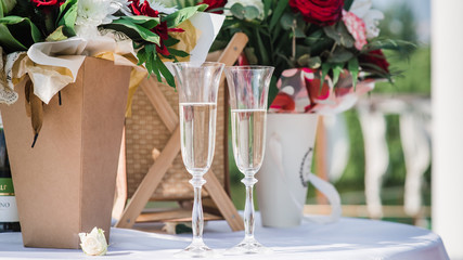 glasses with champagne at a wedding on a background of flowers 2