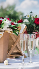 glasses with champagne at a wedding on a background of flowers