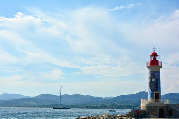 Lighthouse at the port of Saint - Tropez in France, with sea, boats and landscape