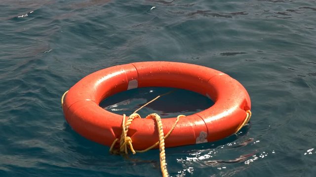a lifebuoy sways on the waves in the sea, serves to save people who have fallen into the water, allows you to swim on the surface for a long time and wait for salvation, close-up
