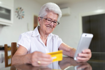 older woman at home with new technologies
