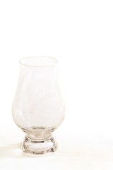 An official whiskey glancairn glass on a white background - portrait view.
