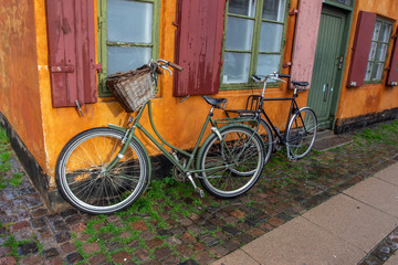 Fototapeta na wymiar two bicycles in front of old house
