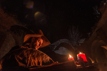 Nostradamus writing his prophesies, fantasy concept. illuminated by candles, long exposure, motion blur, high ISO