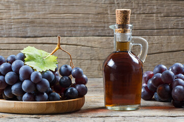Glass bottle of organic black grape balsamic vinegar made from fermented fresh grapes. Healthy...