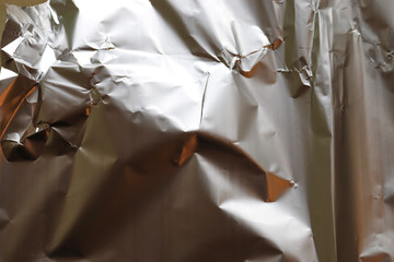 Detailed close up view on a crumpled aluminum foil texture