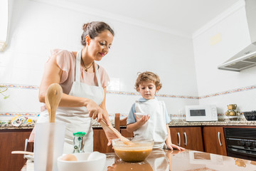Obraz na płótnie Canvas A woman and a child cooking.