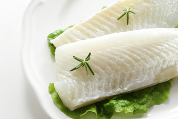 Freshness flat fish fillet on dish with rosemary