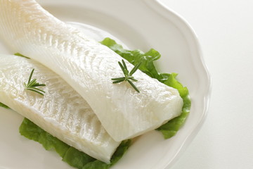 Freshness flat fish fillet on dish with rosemary