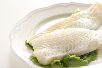 Freshness flat fish fillet on dish with rosemary