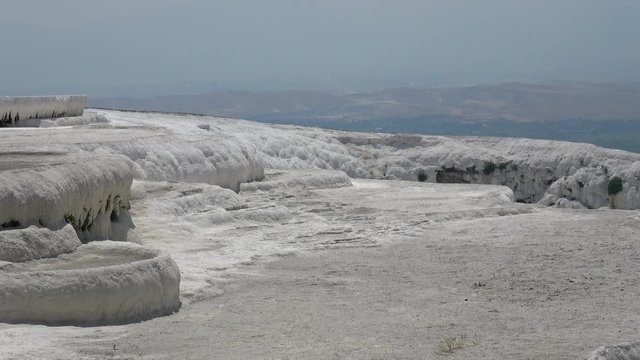 Pamukkale, Denizli, Turkey - 16th of July 2019: 4K Zoom out white sinter terraces with no people on them