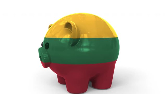 Coins fall into piggy bank painted with flag of Lithuania. National banking system or savings related conceptual 3D animation