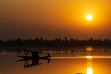 Majestic sunset view over Dal Lake in Kashmir, India. Since 1947 the ownership of Kashmir has been...