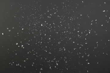 Confetti or artificial snow on black background