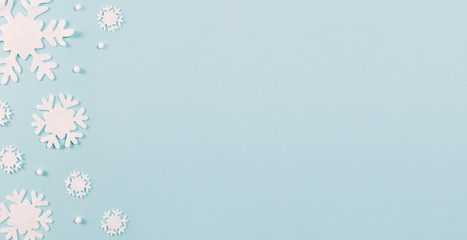 Christmas frame made of snowflakes on blue background with copy space. Christmas concept. Flat lay, top view
