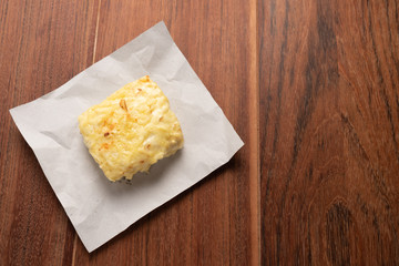 Traditional Croque Monsieur  toasted with cheese and ham topped with bechamel sauce on wooden background