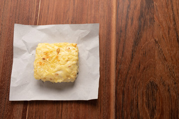 Traditional Croque Monsieur  toasted with cheese and ham topped with bechamel sauce on wooden background