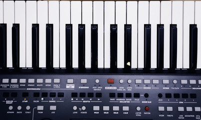 Fototapeta premium piano or electronic synthesizer (piano keyboard) background Midi keyboard and controller with faders and buttons. Concept of close texture pattern music design banner