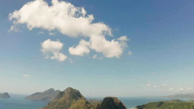 Aerial drone of tropical beach on background of mountains. Seascape with sea, sand, palm trees. Corong corong beach, El Nido, Palawan, Philippines. Summer and travel vacation concept