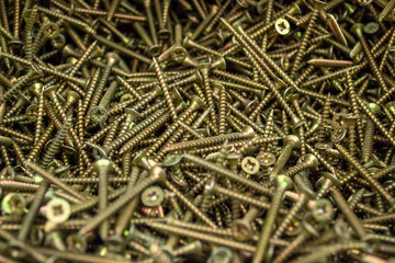 Large number of metal, steel screws. Macro. Close-up. Background and texture.