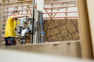 A man in the workshop doing something on modern equipment