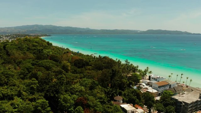 Tropical white sand beach, hotels near the blue lagoon and corall reef. aerial view, Boracay, Philippines. Seascape with beach on tropical island. Summer and travel vacation concept.