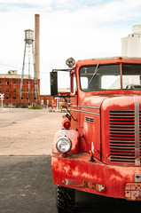 An old firetruck and and abandoned factory sugar mill.