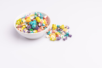 Colored Popcorn candy isolated on white background, soft light, studio shot, copy space. Junk food, fruit flavored popcorn. Colorful, multicolor, candy coated popcorn