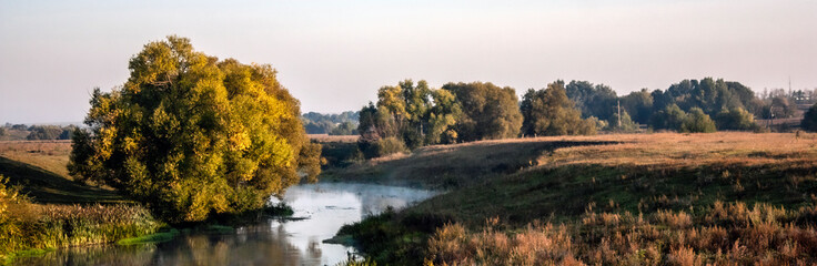 Don river at dawn in the Tula region of Russia. Trees by the river in the morning sun.