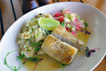 Healthy dish of grilled fish with fresh fruit salsa