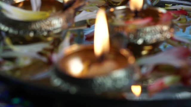 A close up of Oil lamps with flower petals,  for a Hindu festival Diwali, selective focus.