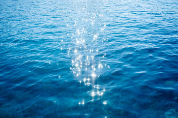 Blue sea surface background with splashing waves