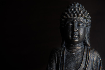 Buddha sculpture on black background