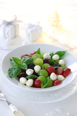 Grape caprese salad on white christmas background