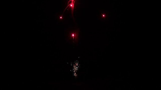 Explosion of bright colorful part of fireworks on black background to create a set salute on video for holiday new year, birthday, wedding or other celebration.