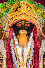 Idol of Goddess Maa Kali at a decorated puja pandal in Kolkata, West Bengal, India. Kali puja is a...