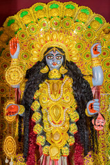 Idol of Goddess Maa Kali at a decorated puja pandal in West Bengal, India. Kali puja is a famous...