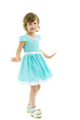 A cheerful little girl is dancing.